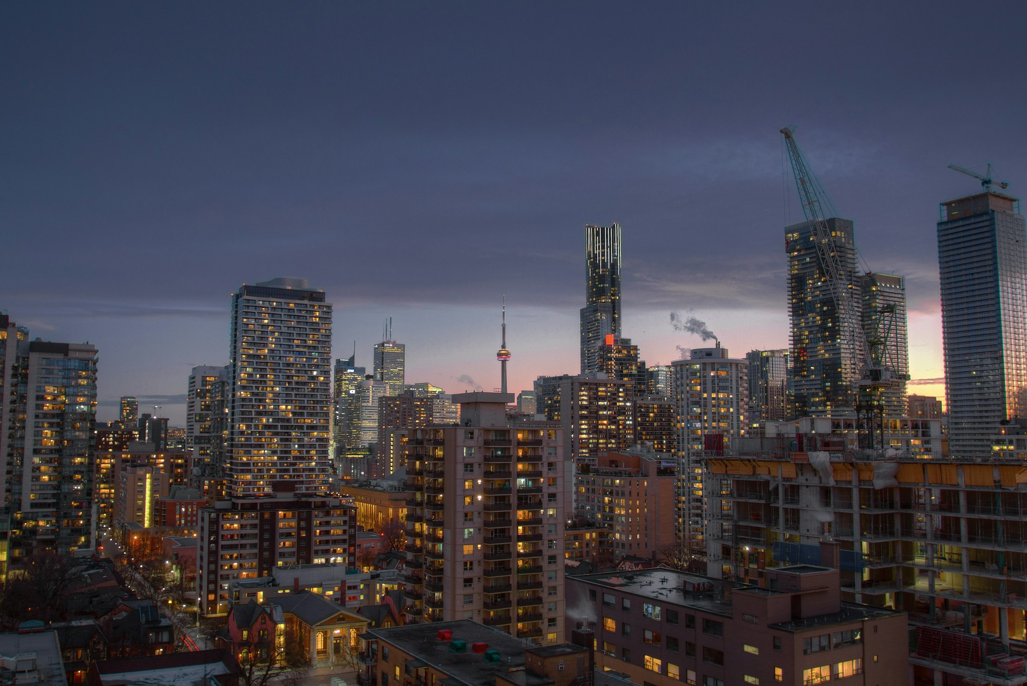 City towers and cranes at dusk